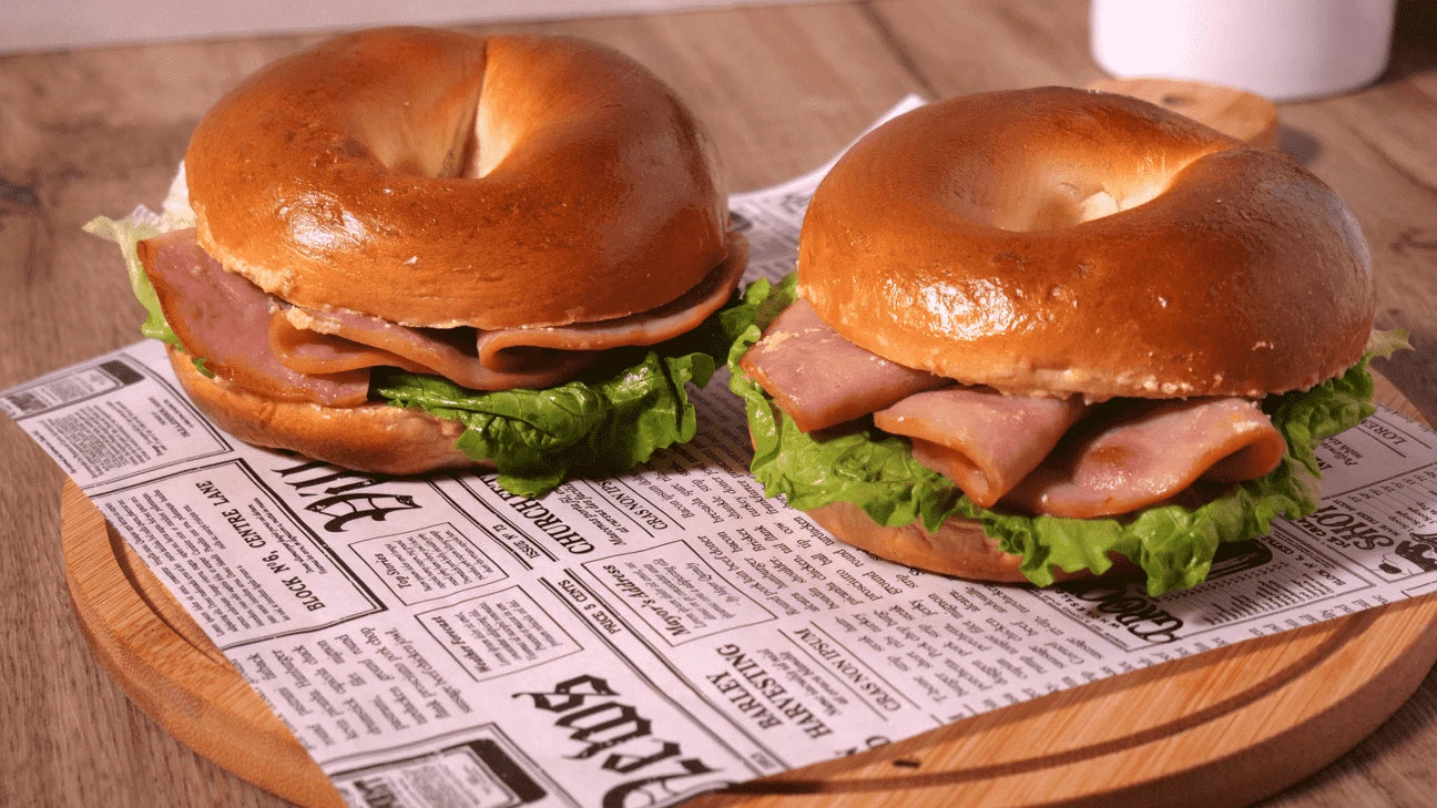 Image of Bagel Sandwiches on Chopping Board with Newspaper