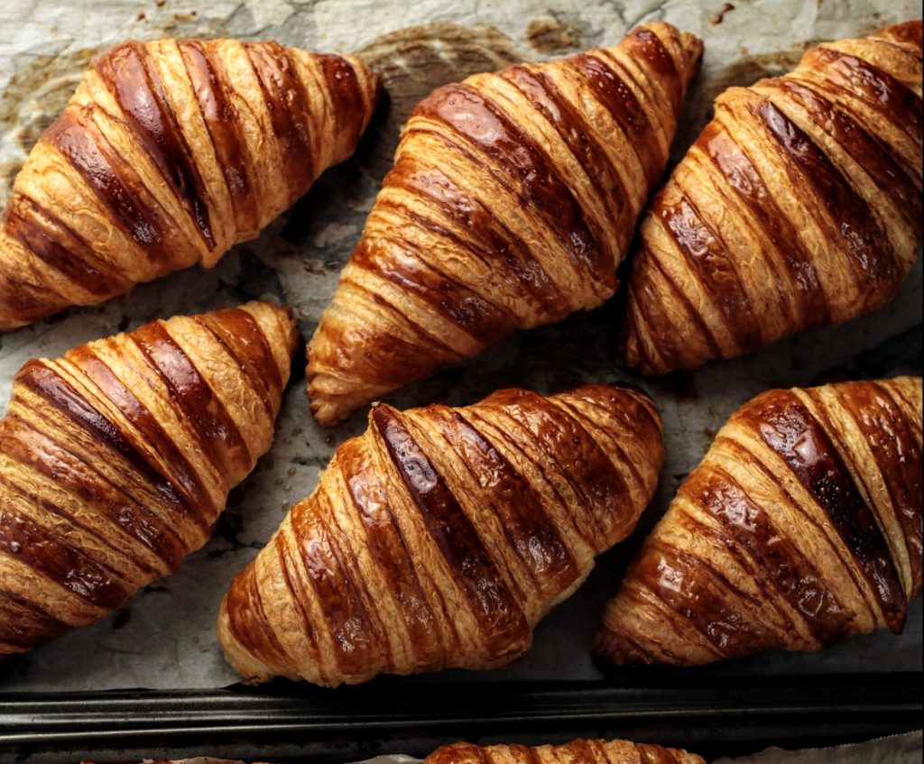 Fresh croissants on marble table top