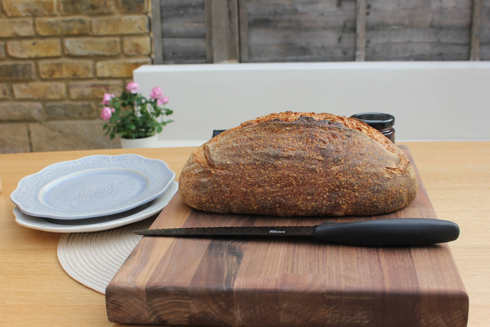 Image of fresh homemade sourdough loaf on wooden chopping board