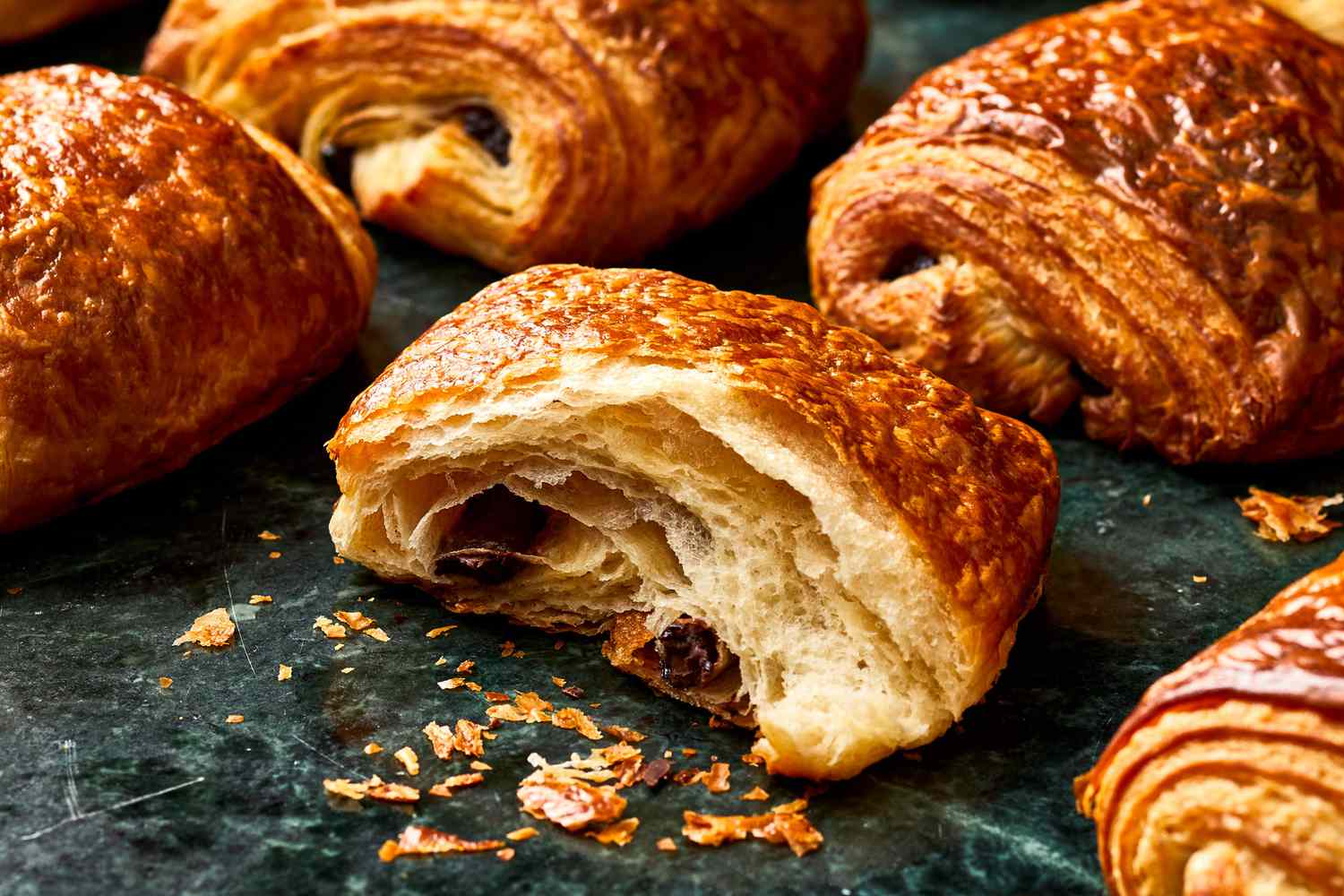 Flaky pain au chocolates cut in half.