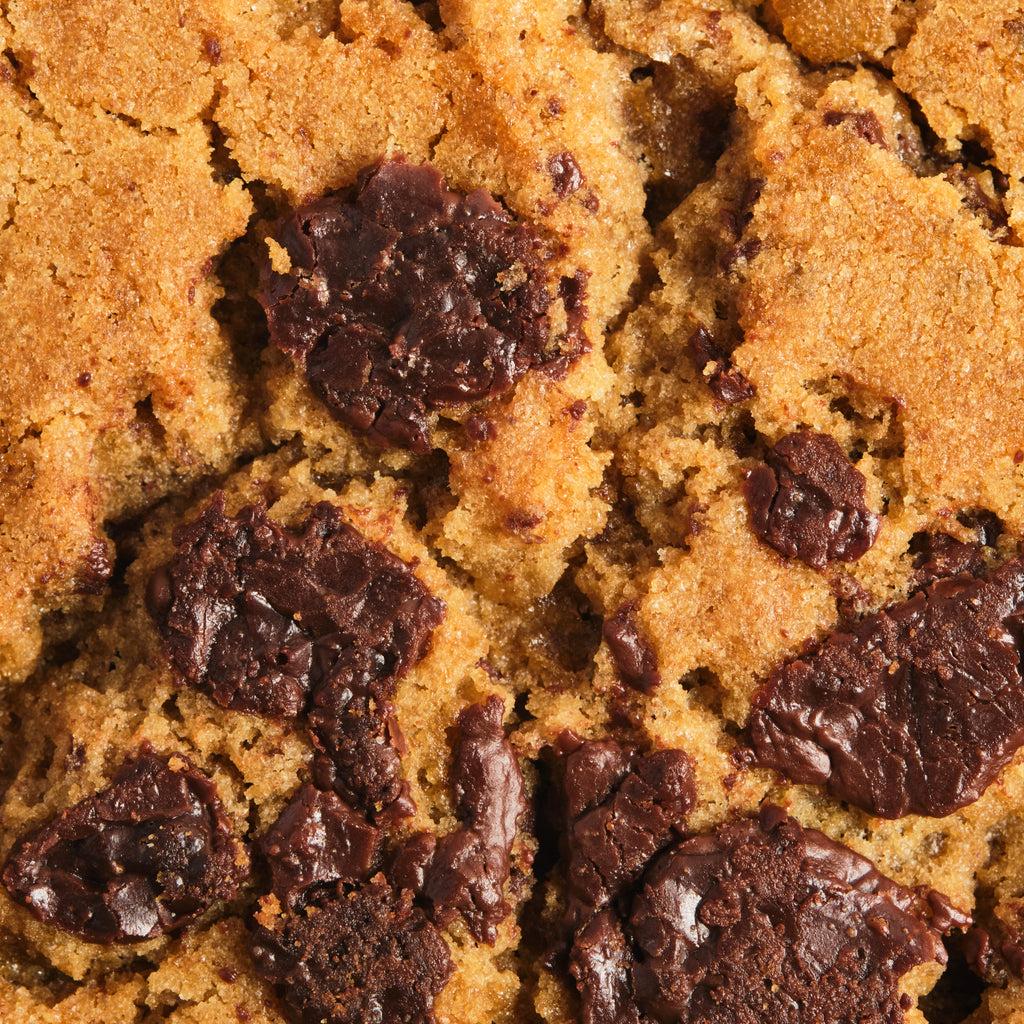 Close-up of a chocolate chip cookie showing texture and chocolate chips.