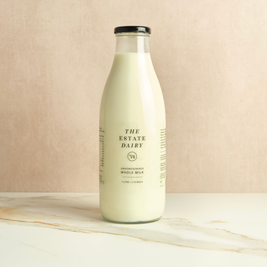 Bottle of milk from The Estate Dairy on a beige background.