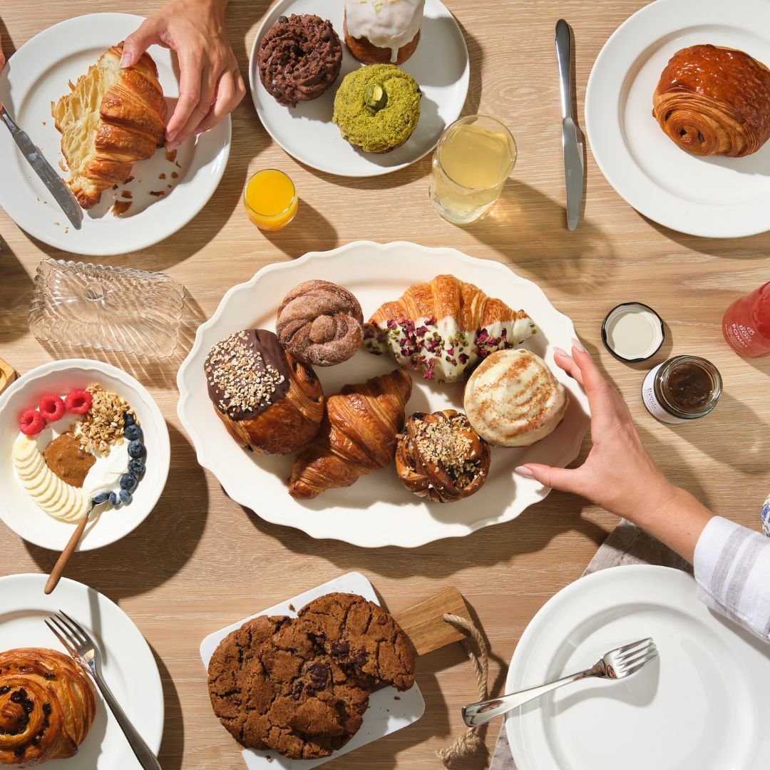 Friends sharing a freshly delivered weekend breakfast